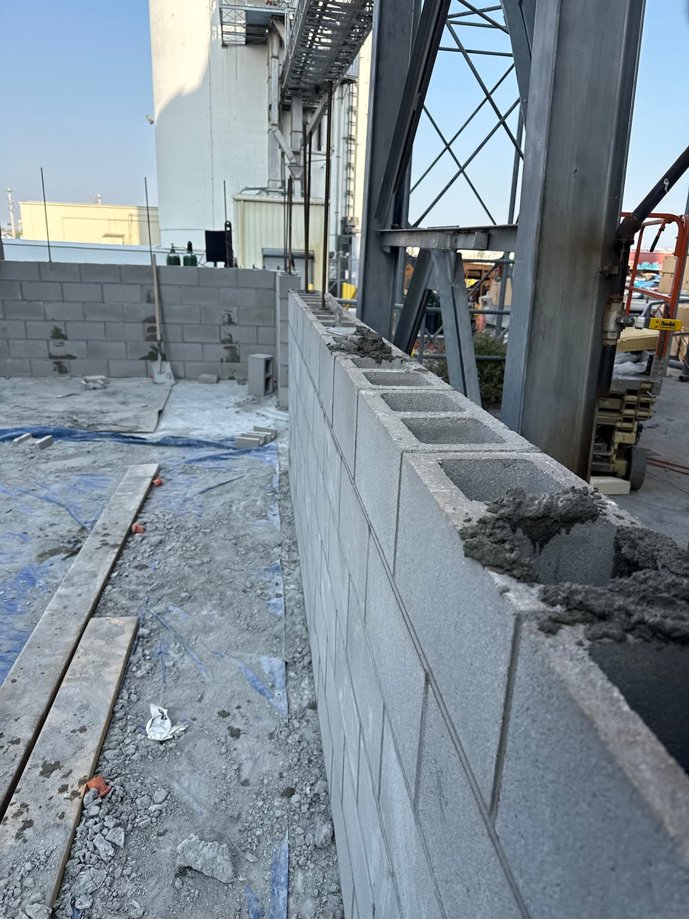 Reinforced concrete block wall under construction on a commercial site